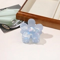 Close-up of a light blue iridescent flower hair claw clip with a pearlescent finish - PVC 7cm Flower - Iridescent Blue