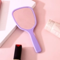 Elegant handheld makeup mirror with a purple handle and ergonomic rectangular design - Violet