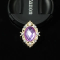 Detailed close-up of a vintage purple gemstone brooch with a golden crystal frame - Light Purple