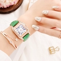 Close-up of elegant square quartz watch with green leather strap and gold bracelets - Green Watch + Bracelet
