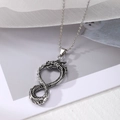 Retro punk dragon pendant necklace in antique silver with bone chain on white fabric - Style 2: Infinite Dragon
