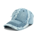 Detailed view of frayed edges and distressed texture on light blue denim baseball cap - Light Blue