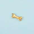 Gold dog bone pendant with purple zircon stone and small metal connecting ring - Gold June