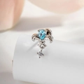 Zilveren iris oorknopje met peervormige blauwe zirkoon en klein rond kristal - Licht Zeeblauw (1 Stuk)