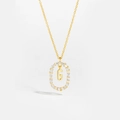 Detailed close-up of 18K gold letter G pendant with sparkling diamond-set oval frame - Letter G