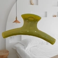 Translucent olive green 15cm hair claw clip shown in a minimalist bedroom setting - Butterfly Back Style / Extra Large (Approx. 15cm) / Seedling Green