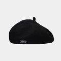 Close-up of the 1987 embroidery detail on a black wool blend beret hat for women - One Size(Adjustable) / Black