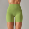 Detail view of high-waist green yoga shorts with flatlock seams and matte texture - Medium Fruit Green