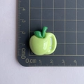 Glossy green apple resin charm shown next to a ruler for 2cm size scale reference - Green Apple