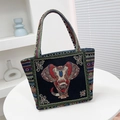 Ethnic black canvas tote bag featuring colorful embroidered elephant pattern - Black Front Elephant