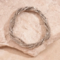 Detail van een zilveren meerlaagse strass armband op een natuursteen achtergrond - Zilver