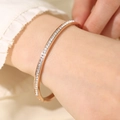 Close-up of rose gold bangle with square-cut cubic zirconia inlays on wrist - Rose Gold (29-D-11)