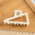 Triangle hair claw clip with faux pearls in white finish on wooden tray - Hollow Triangle