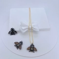 Detailed view of bee pendants in copper with inlaid zirconias on a gold chain necklace - Gold Tri-color Bee Set