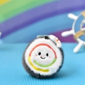 Close-up of a cute sushi-shaped plush pendant with rainbow embroidery and soft texture - Sushi