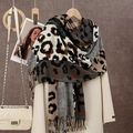 Detailed close-up of soft leopard print cashmere-like scarf with fringe edges and tassels - 180*70cm / Black Gray