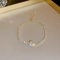 Detail of adjustable gold tennis bracelet with zircons and pearls on mirror surface - Gold Geometric Square Style / Gold
