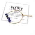 Detail of a gold chain bracelet featuring dark blue irregular crystals with a lobster clasp - Lapis Lazuli