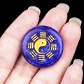 Lapis lazuli stone disc featuring a golden yin yang and bagua symbol carving - Lapis Lazuli