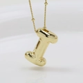 Macro shot of 3D puffy gold letter I pendant with a polished mirror finish on white background - Letter I (Necklace)