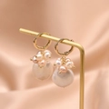 Baroque pearl earrings with golden chain and pink clusters on pink silk background - White Pink Purple Pearl Cluster Earrings