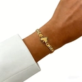 Golden watch-band style chain bracelet featuring a beaded heart charm on a model's wrist - Heart Bracelet (Gold)