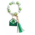 Macro view of St. Patrick's Day beaded bracelet with green clover charm and white tassel - US 6