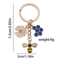 Golden keychain with bee honeycomb and sunflower charms featuring enamel and crystals - Honeycomb Bee Rhinestone