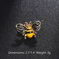 Detail view of small bee brooch measuring 2.1 by 1.4 cm with yellow and black enamel finish - Little Bee Style (XD8869-1)