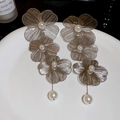 Detailed view of silver flower earrings with metal mesh petals and white pearls on a plate - Triple-layer Hollow Petal Pearl Long Style (Silver) / Silver