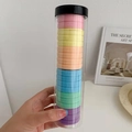 Close-up of colorful macaron elastic hair ties in a transparent cylindrical plastic tube - 20 Pieces Canned / Macaron Color