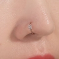 Close-up of a rose gold flower nose ring with sparkling crystals on a model's nose - Flower Shape / Rose Gold