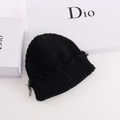 Detail of black ribbed knit beanie with frayed edges on a white background - Black