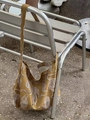 Outdoor shot of the leopard print canvas tote bag hanging on a metal bench seat - Single Strap Crossbody Style