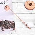 Rose gold candle snuffer with bell head and non-slip handle on a rustic wooden table - Rose Gold Candle Snuffer Bell