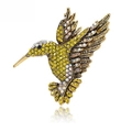 Elegante broche de colibrí dorado con diamantes amarillos sobre un fondo blanco - Amarillo Limón