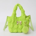 Detail of neon green quilted bubble texture handbag with gold metal bow and pompom charm - Fruit Green