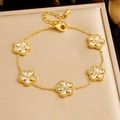Detailed shot of gold plated flower bracelet with zircon stones and beaded texture edges - White Flower Style (B2005)