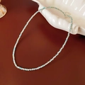 Detail of Amazonite beaded necklace with silver spacers on a white shell tray - Sky Blue Amazonite Style 2