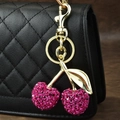 Sparkling pink crystal cherry keychain with gold metal leaf on black leather bag - Rhinestone Cherry Gold Leaf Rose Red