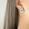 Silver square stud earrings with sunburst texture and green gemstones on model - Steel Color Green Glass Stone Earrings
