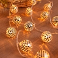 LED disco ball string lights with warm yellow glow on a rustic dark wood surface - 6m 40 LEDs Battery Operated