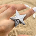 Retro pentagram ring in silver finish with radial texture on a sandy background - Silver