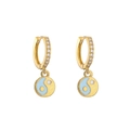 Macro detail of gold-plated hoop earrings with micro-pave zircons and blue yin-yang charm - Light Blue Gold Tai Chi
