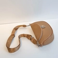 Women's camel pebble leather saddle bag with wide woven strap and silver hardware - Tan