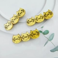 Close-up of glittery golden acetate cat hair clips on a white minimalist background - Shiny Gold