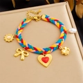 Detail of colorful woven rope bracelet with gold sun pendants and pearl accent - Bow and Red Heart Style (B1796)