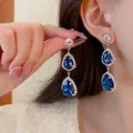 Detail view of double teardrop blue crystal earrings with zircon halo on model - Dark Blue Rhinestone Water Drop Stud Earrings