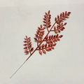 Close-up of artificial Christmas leaf branch with dense red glitter coating decoration - Red