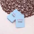 Close-up of stacked light blue thank you cards with simple arrow icons on a textured surface - Simple Thank You Card - #4 Light Blue